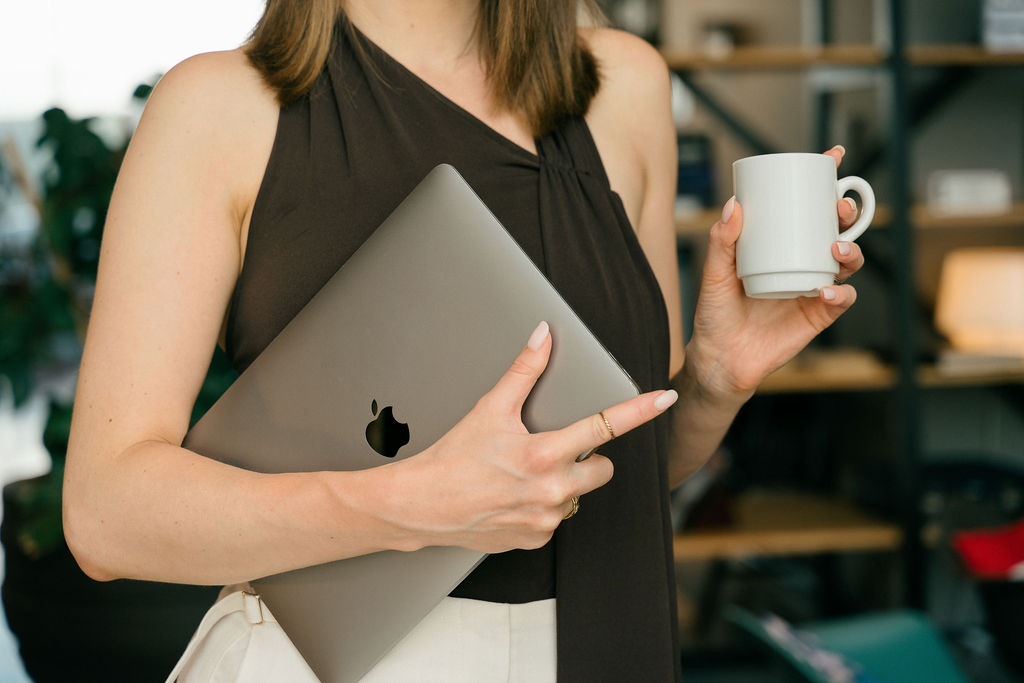 A close-up moment of solopreneur work — laptop and coffee